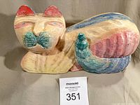 Full view of carved wooden cat sculpture with lot tag