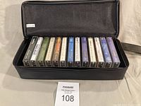 Open Discwasher case showing 13 cassette tapes in holders