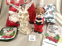 Group shot showing all items: basket, wreath hugger, angel, choirboy, towel, pot holders