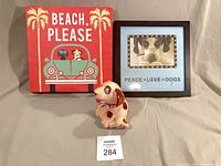 Group shot of plaque, framed art, and figurine