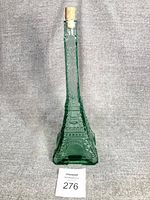Full view of green glass Eiffel Tower bottle with cork