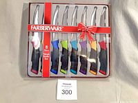 Front view of boxed 8-piece Farberware steak knife set with multicolor handles