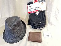 Overall view of lounge pants in packaging on hanger, grey fedora hat, brown wallet