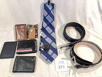 Group shot of tie, wallets, belts