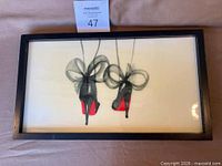 Front view of framed artwork showing shoe design