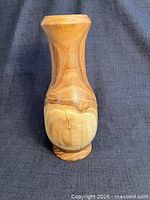 Front view of hand-turned wooden vase showing grain patterns and shape