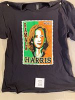 Front of black t-shirt with Kamala Harris graphic and lot tag