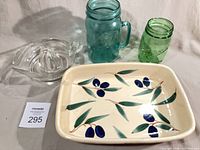 Group shot of ceramic dish, two mason jars and glass juicer