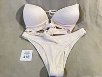 Full view of two-piece swimsuit laid flat showing both top and bottom