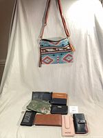 Overall lot showing handbag and seven wallets/wristlets