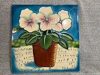 Full front view of square ceramic flower tile plaque
