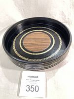 Top view of the round leather tray showing wood veneer centre and gold trim