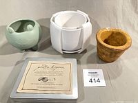 Group shot of all items: frog planter, white nesting planters, terra cotta pot, Garden Keepers seed kit