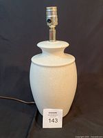 Full view of ceramic table lamp showing overall design and cord