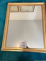 Full view of mirror with gold frame