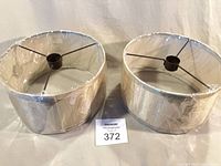 Front view of both lampshades still wrapped