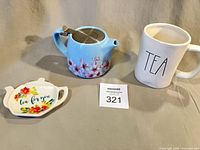 Full lot view showing teapot, Rae Dunn cup, and teabag rest