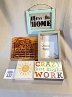 All five wooden signs displayed together