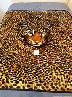 Full view of throw blanket on bed showing tiger face design
