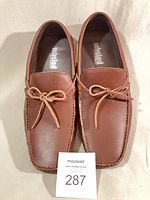 Top view of both loafers showing leather, laces, and Unlisted insoles