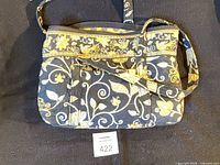 Front view of handbag showing overall design and strap