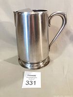 Full view of stainless steel Brandware pitcher showing overall shape, handle, base