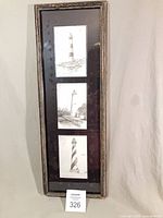 Full view of framed triple lighthouse drawings