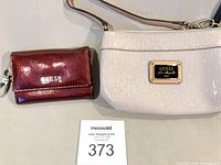 Overall view of Guess cream handbag and red wallet