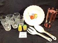Group view of all items including glasses, bowl, shakers, serving utensils, cheese cutlery on stand