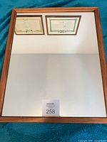 Full view of mirror showing wooden frame and reflective surface