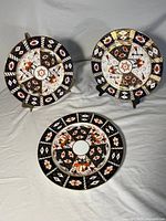 Front view of three Royal Crown Derby Imari plates