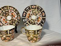 Front view of two cup and saucer sets showing pattern and color