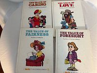 Front covers of four books: Caring, Love, Fairness, Foresight