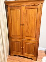 Front view of four-door solid wood armoire