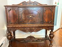 Front view of carved wooden hutch cabinet