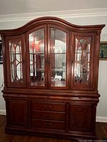 Front view of entire hutch showing glass doors, drawers, cabinet doors