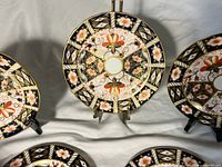Front view showing pattern and four flat-rim dishes plus one scalloped (center)