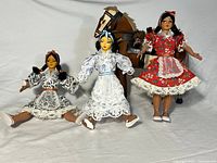 Front view showing three dolls and horse figurine