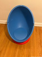Front view of blue egg chair on red base