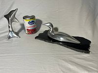 Both Hoselton aluminum sculptures with can for scale