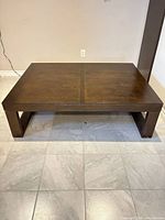 Full view of rectangular wood coffee table on tiled floor