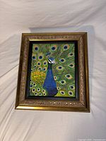 Front view of framed hand-painted peacock artwork