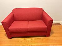 Front view of red loveseat sofa