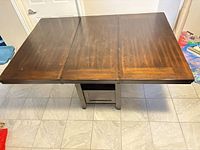 Full overhead view of rectangular dark wood dining table with center leaf inserted