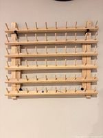 Front view of pine thread spool rack with pegs