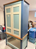 Full view of painted wooden wardrobe cabinet