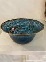 Angled view of bowl interior showing translucent enamel and floral pattern