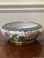 Side view of cloisonné bowl showing peony motif, ruyi rim, gilt foot