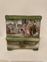 Front view showing Grecian market scene and green glazed rim/base