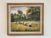 Close view of framed painting showing artwork details and signature